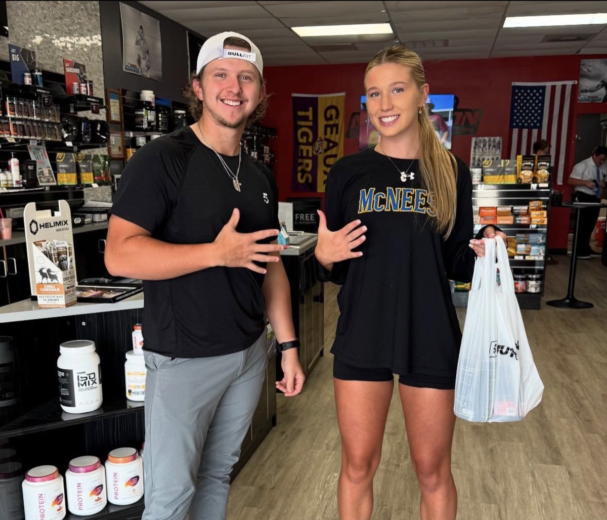 5 Star employee and customer posing together with a shopping bag full of products