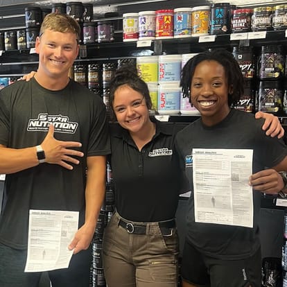 5 Star employee posing with customers holding their InBody scan results
