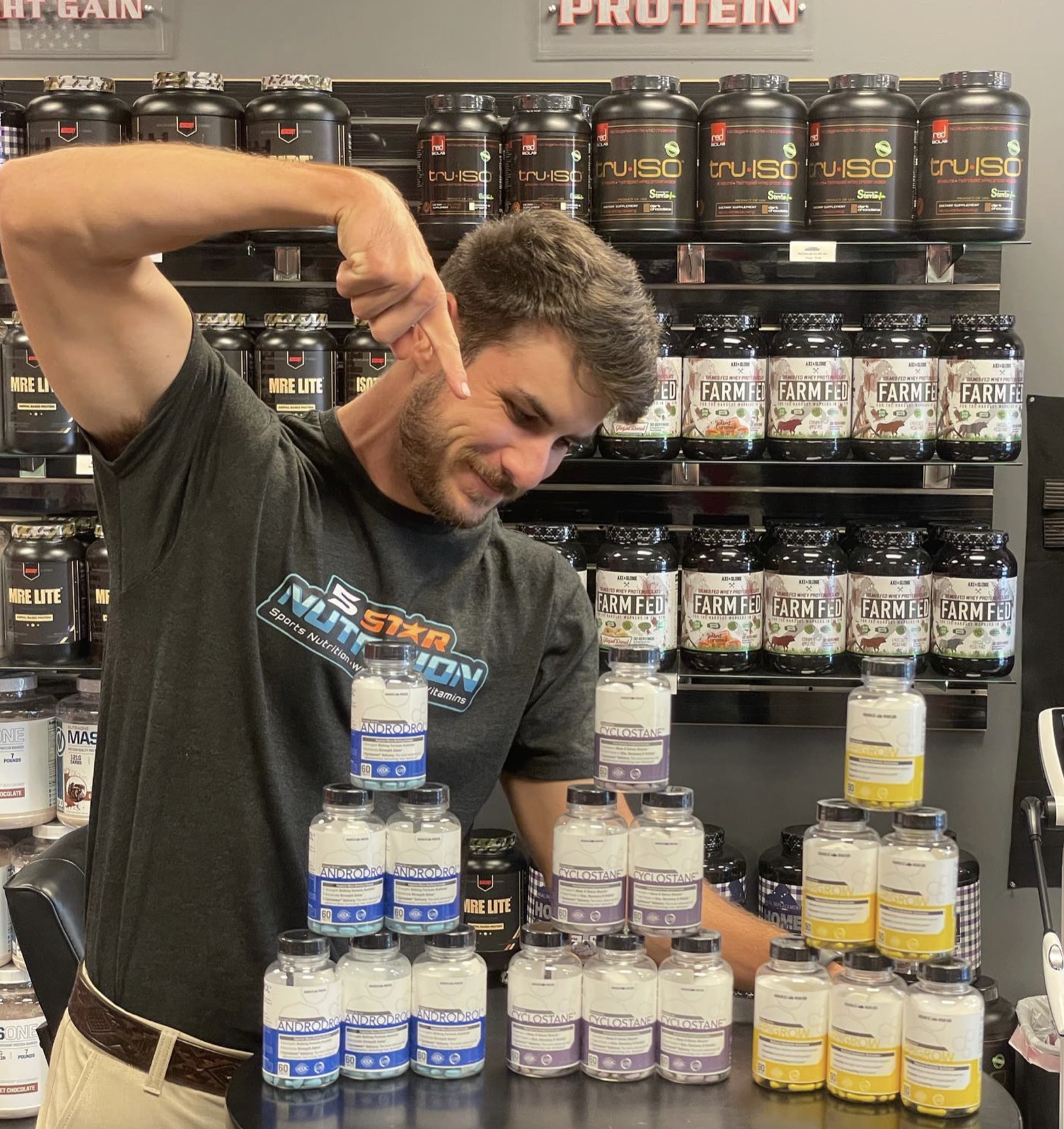 5 Star team member posing with supplements