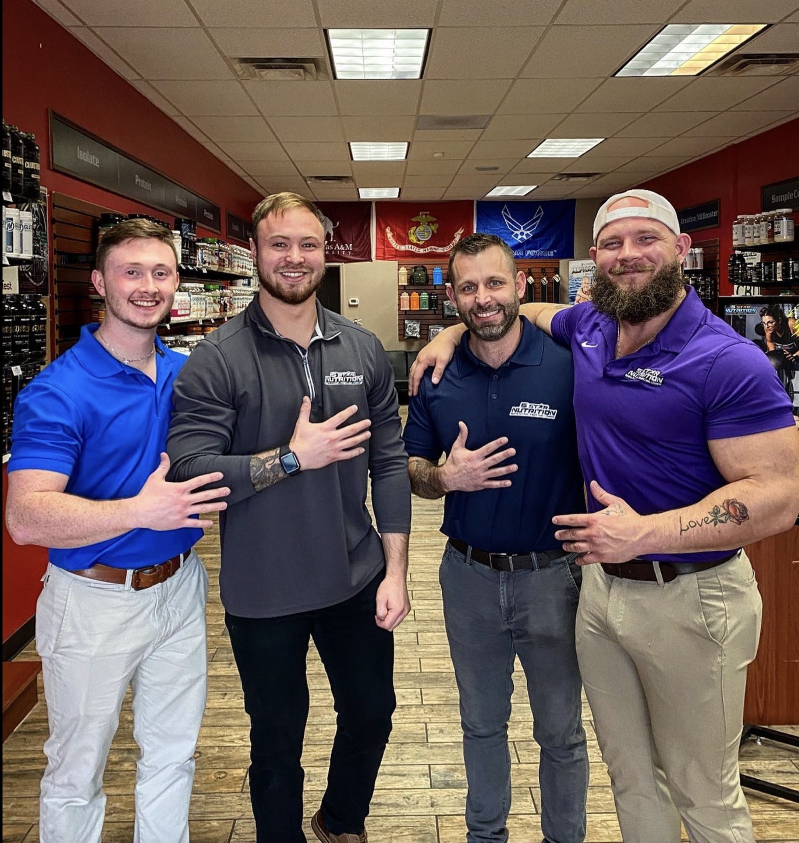 A group of 5 Star team members posing together in a store