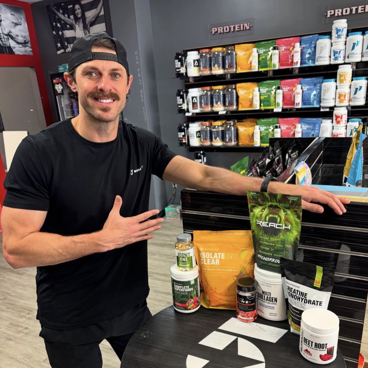 Franchise owner John Maler posing with supplements in his Lake Charles store