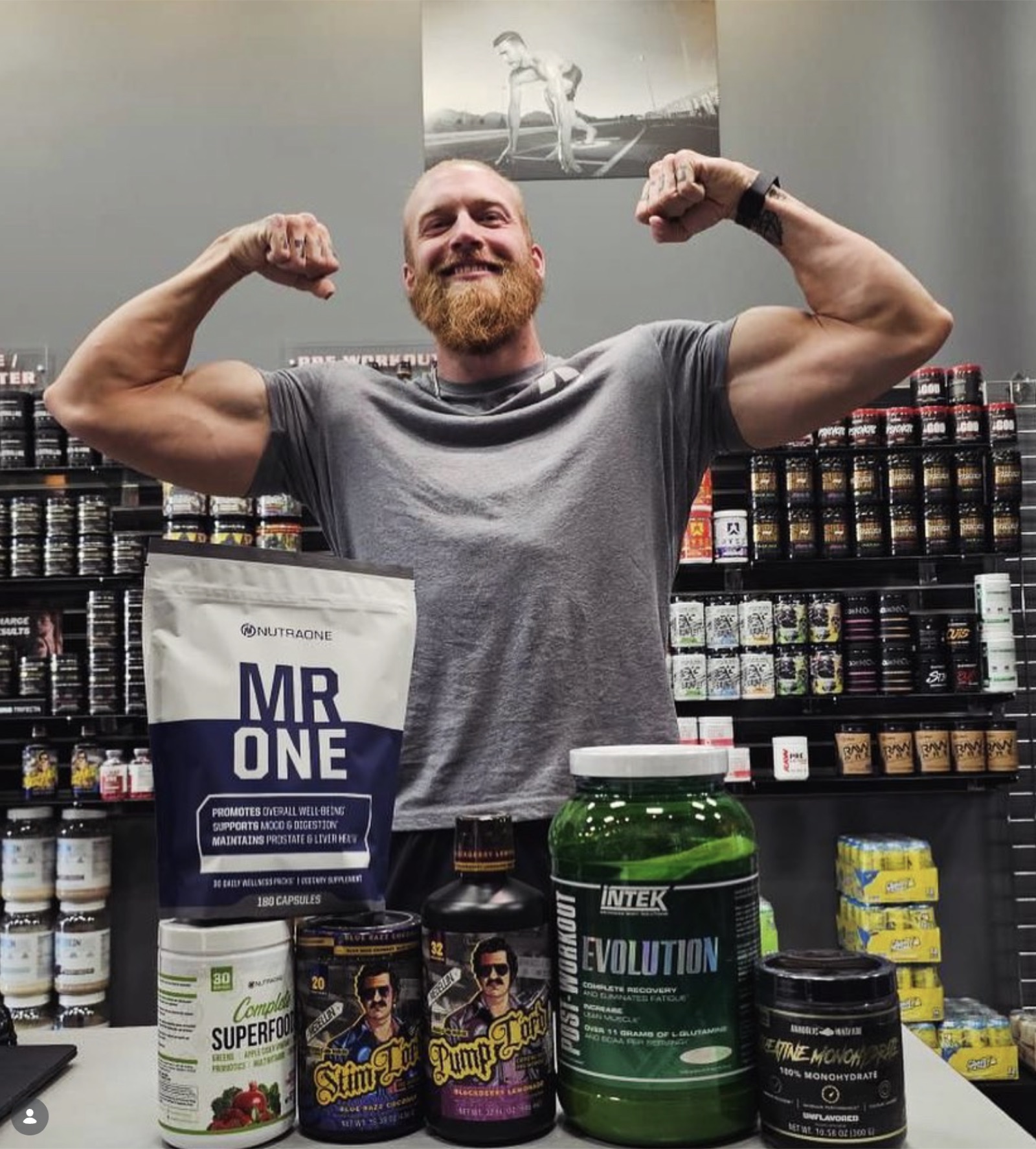 5 Star team member flexing their muscles and posing with supplements