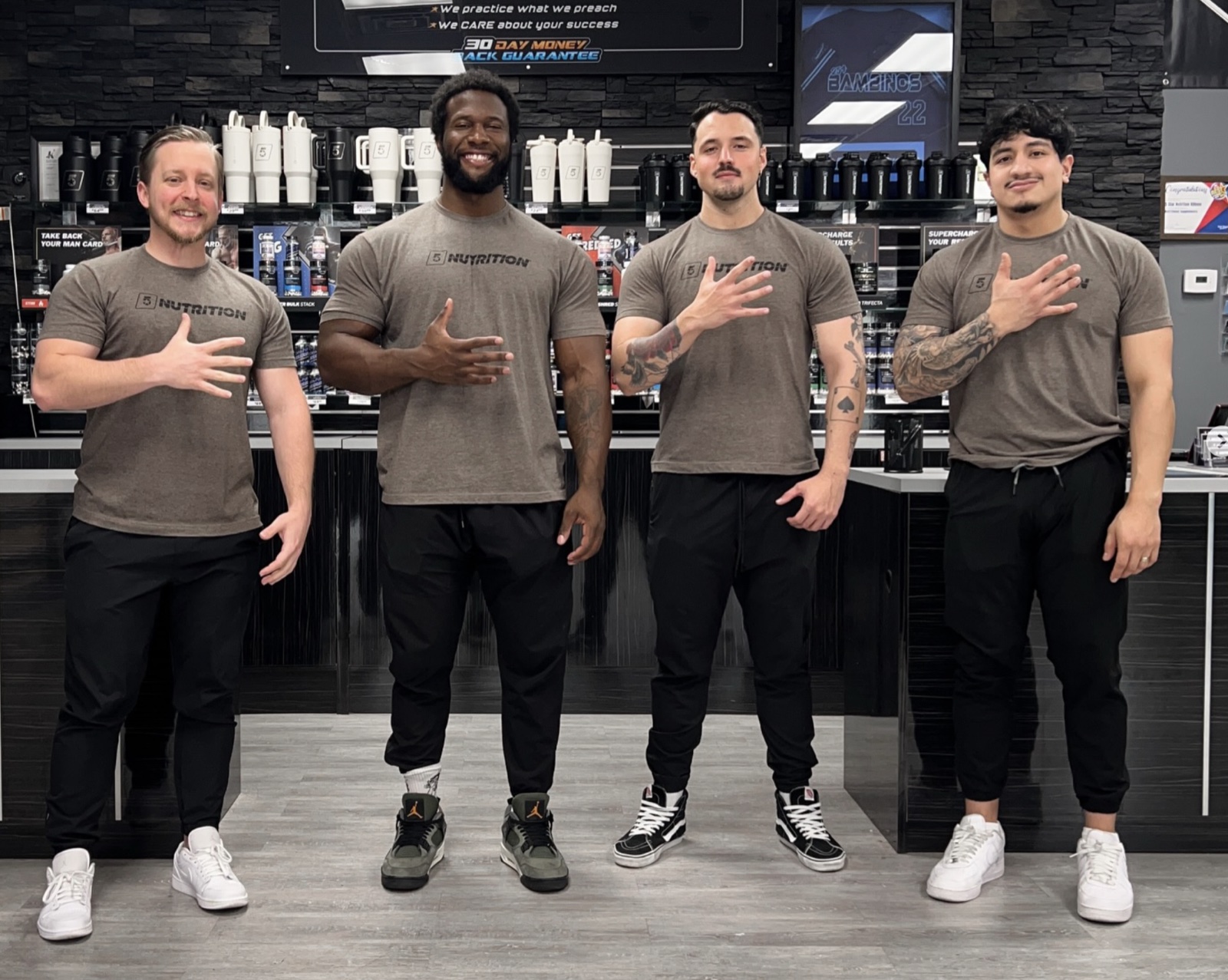5 Star employees posing together in a store