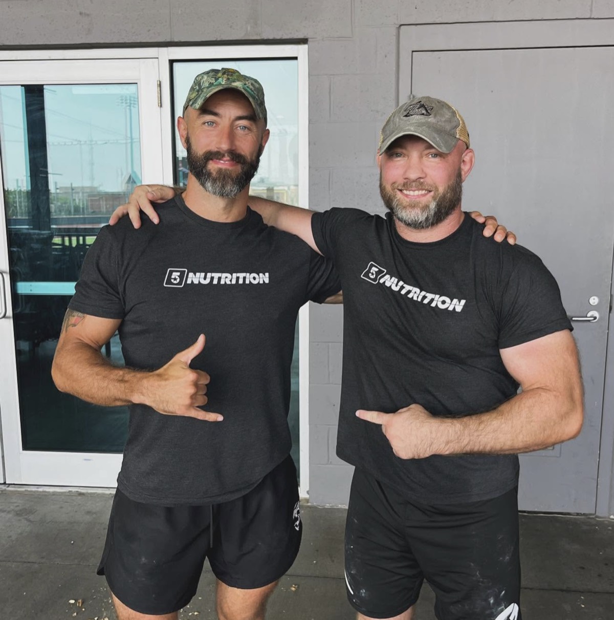 Two men posing together in 5 Star t-shirts